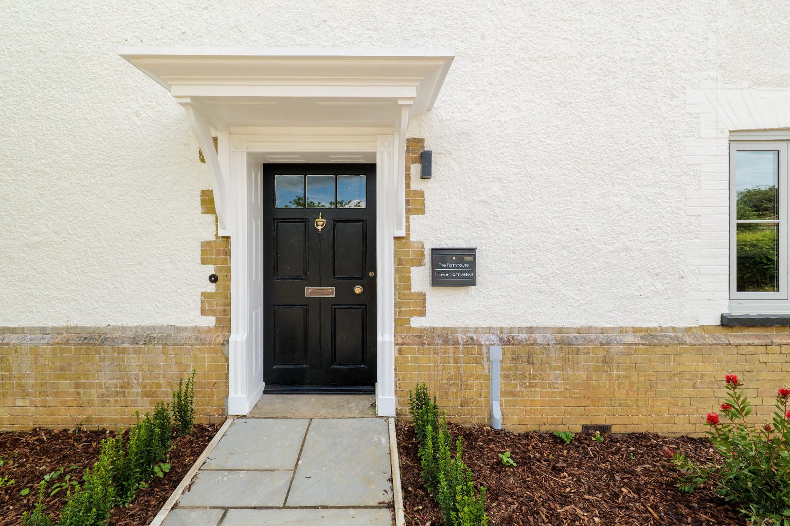 Black front door repaint on brick new-build, Lower Farm Mews
