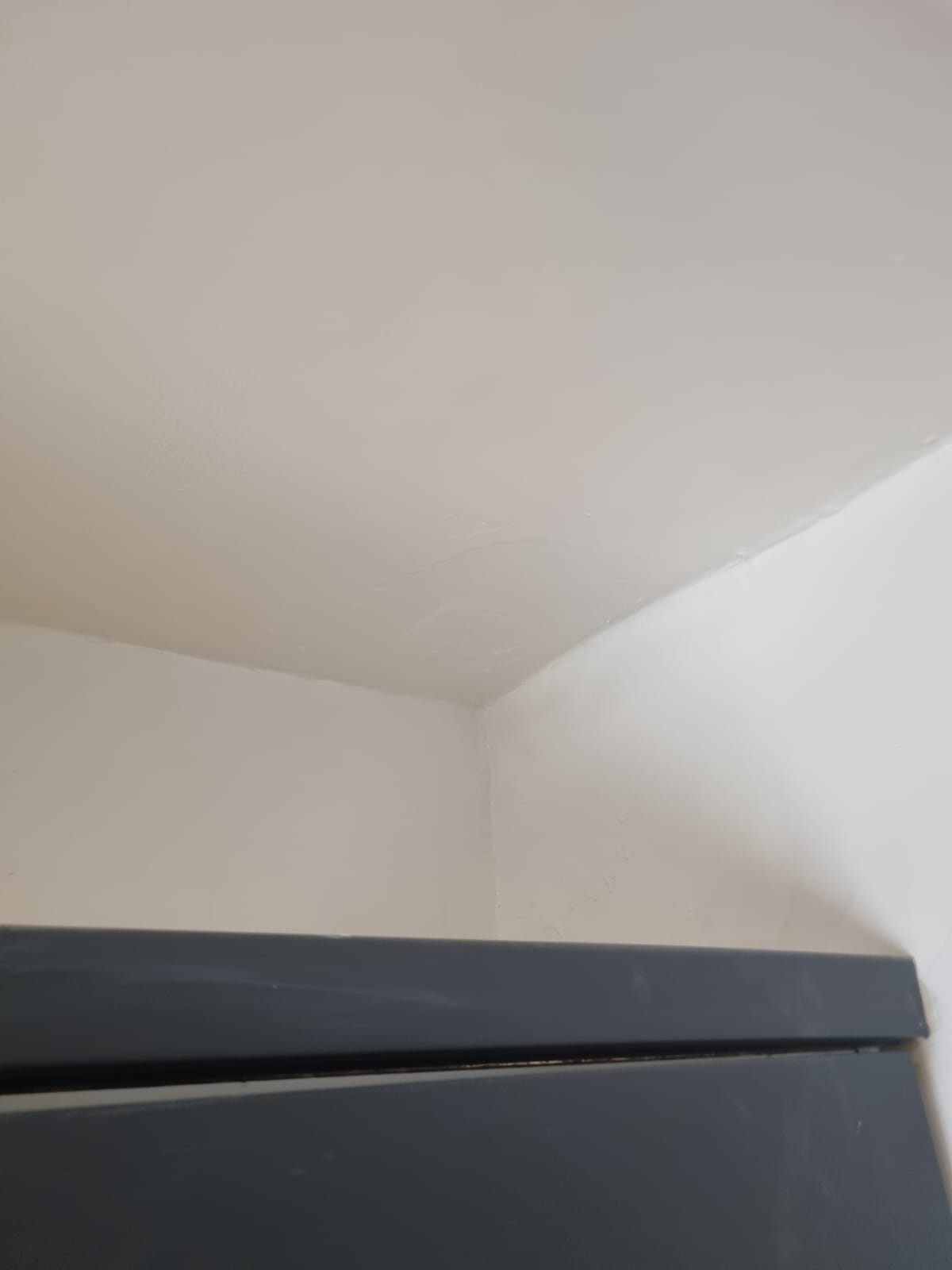 Repaired and repainted ceiling corner, after